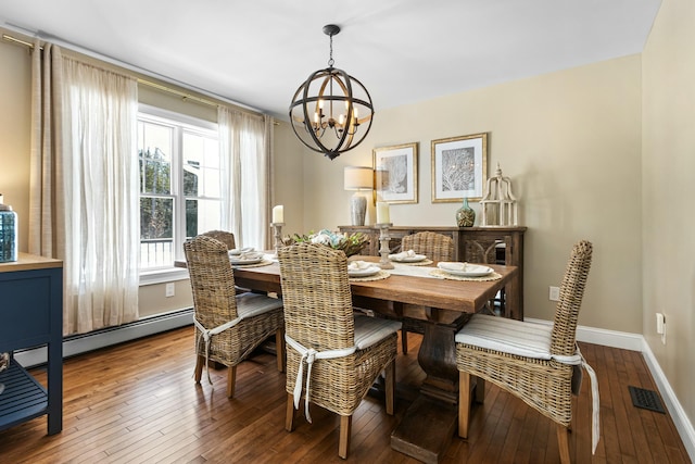 dining room featuring visible vents, baseboards, hardwood / wood-style flooring, a baseboard radiator, and a chandelier