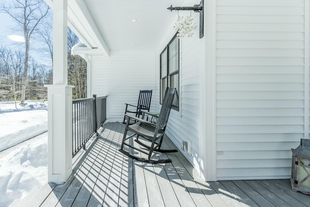 snow covered deck with covered porch