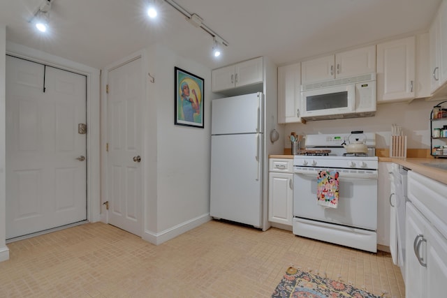 kitchen featuring white appliances, baseboards, white cabinets, light countertops, and track lighting