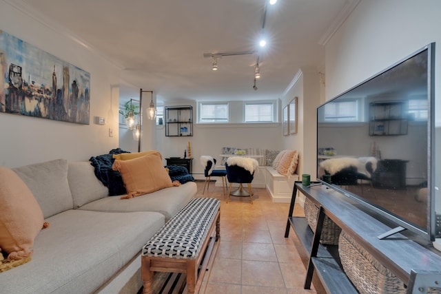 living room featuring track lighting, crown molding, and light tile patterned flooring