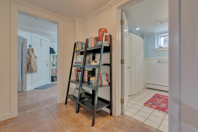 hall featuring light tile patterned floors, baseboard heating, and crown molding