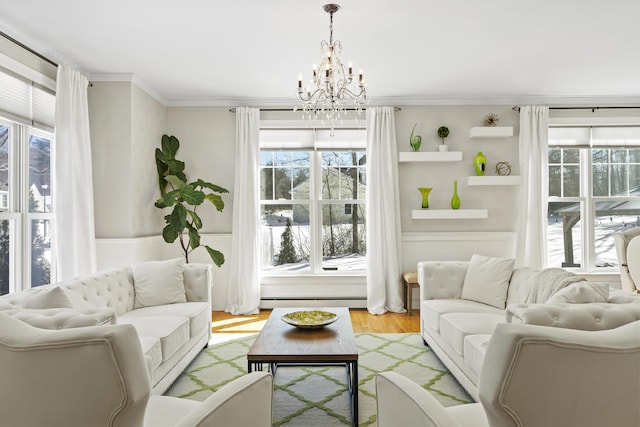 living room with a baseboard radiator, plenty of natural light, wood finished floors, and ornamental molding