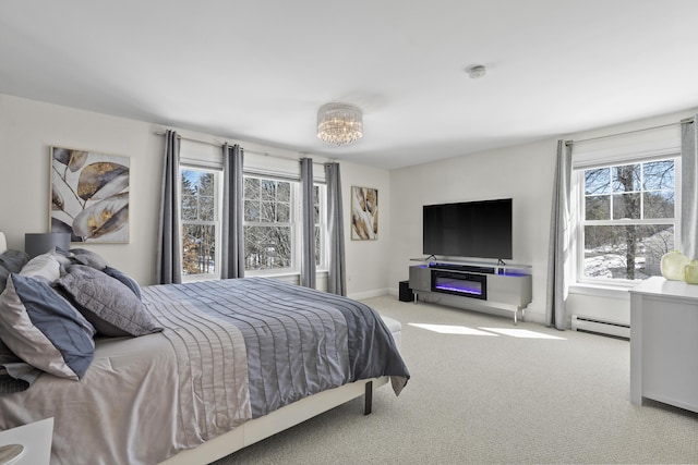 carpeted bedroom featuring a baseboard radiator and baseboards