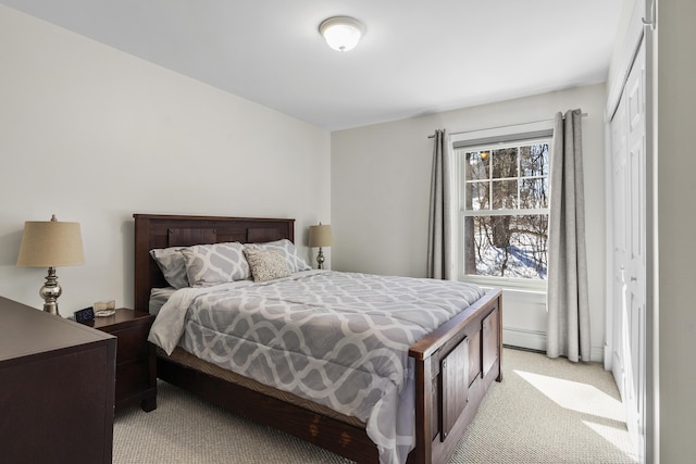 bedroom featuring light colored carpet and a baseboard radiator