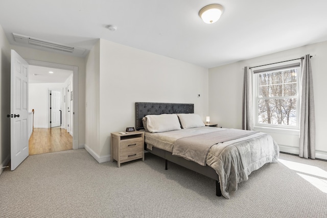 bedroom with baseboards, visible vents, and light carpet