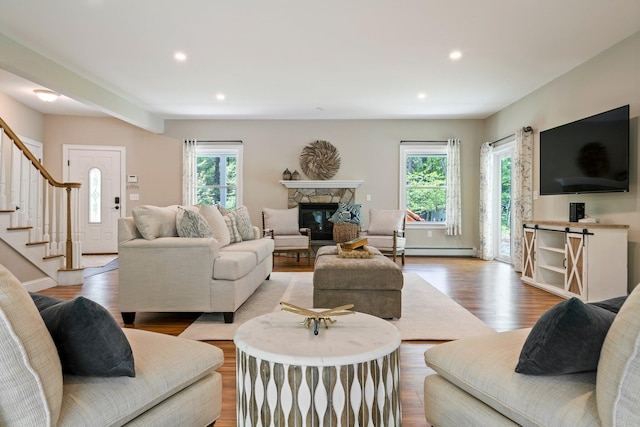 271 Red Gate Ln, Acton, ME 04001 - living room with plenty of natural light, a stone fireplace, wood finished floors, baseboard heating, and recessed lighting