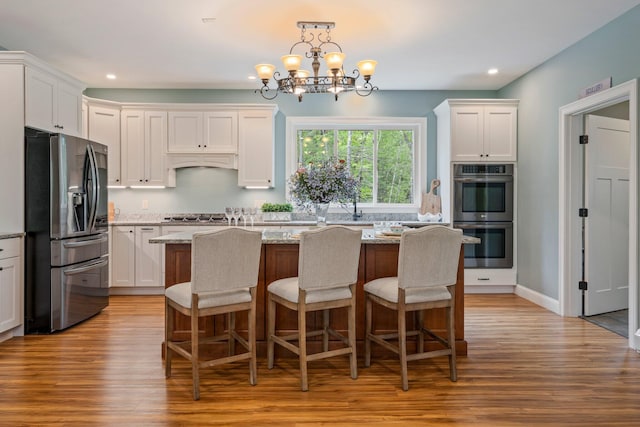 271 Red Gate Ln, Acton, ME 04001 - kitchen with stainless steel appliances, light wood-type flooring, white cabinetry, recessed lighting, and a center island