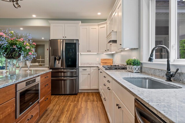 271 Red Gate Ln, Acton, ME 04001 - kitchen with stainless steel appliances, light wood-style flooring, white cabinets, recessed lighting, and light stone counters
