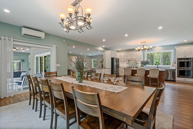 271 Red Gate Ln, Acton, ME 04001 - dining area featuring a chandelier, an AC wall unit, light wood-type flooring, and recessed lighting