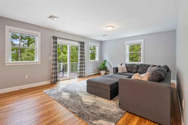 271 Red Gate Ln, Acton, ME 04001 - living room featuring a baseboard heating unit and light wood-type flooring