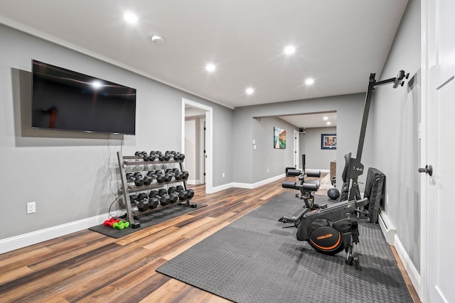 271 Red Gate Ln, Acton, ME 04001 - workout room with wood finished floors, recessed lighting, a barn door, and a baseboard heating unit