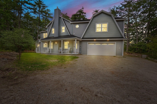 271 Red Gate Ln, Acton, ME 04001 - view of front facade with a porch, dirt driveway, a garage, a chimney, and a gambrel roof
