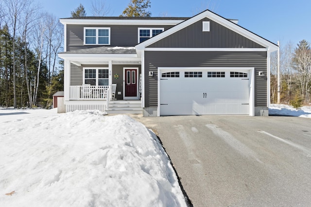 view of front of home featuring an attached garage, driveway, and a porch