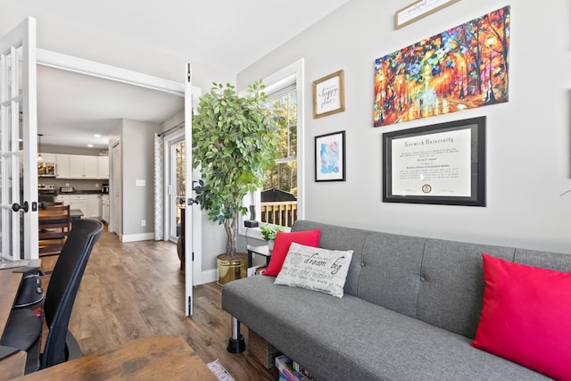 living room with baseboards and wood finished floors