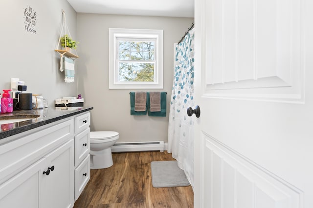 full bath featuring toilet, a baseboard radiator, wood finished floors, and vanity