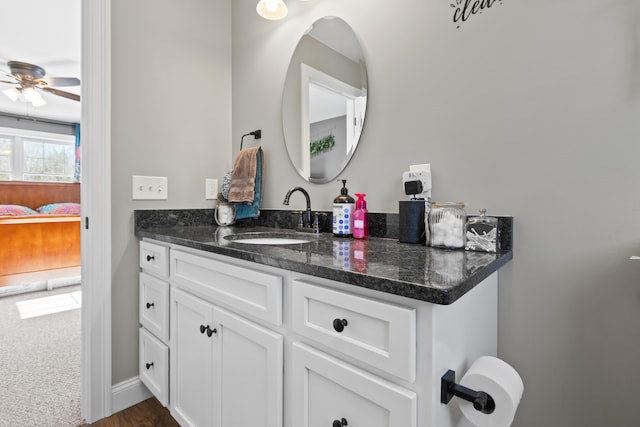 ensuite bathroom featuring connected bathroom, baseboards, a ceiling fan, and vanity