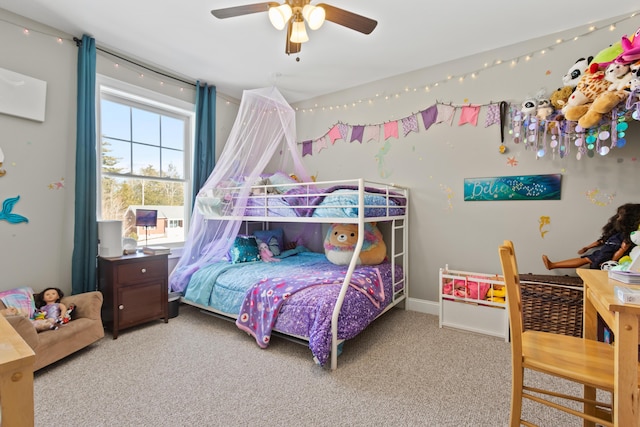 carpeted bedroom featuring ceiling fan and baseboards