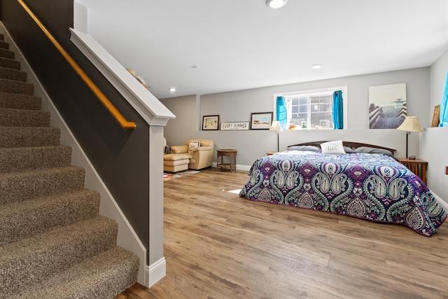 bedroom with recessed lighting, baseboards, and wood finished floors