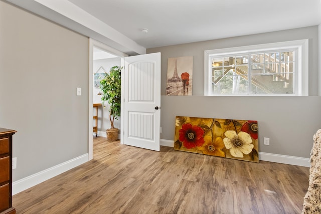 recreation room with wood finished floors and baseboards