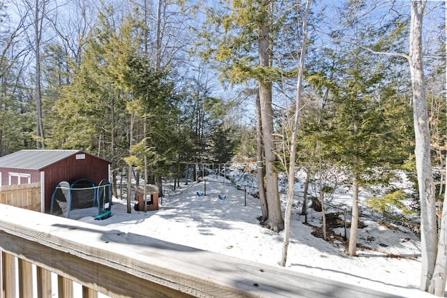 yard layered in snow featuring an outdoor structure and fence