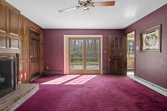 unfurnished living room featuring a fireplace, carpet floors, and baseboard heating