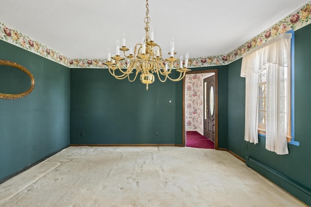 unfurnished room featuring an inviting chandelier, baseboards, baseboard heating, and carpet flooring