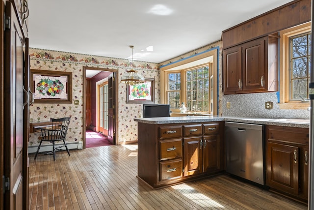 kitchen with a baseboard heating unit, dishwasher, dark wood-style floors, and wallpapered walls