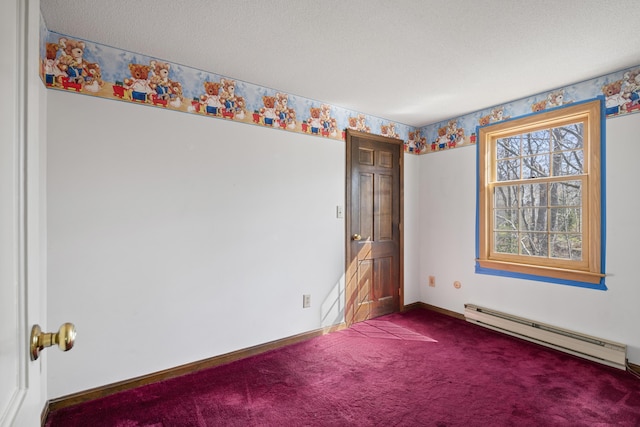 spare room featuring baseboards, baseboard heating, and dark colored carpet