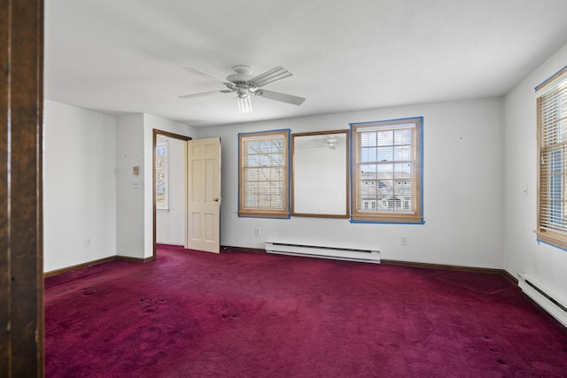 carpeted empty room with a baseboard heating unit and a healthy amount of sunlight
