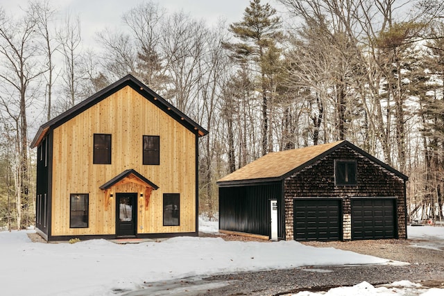 snow covered garage featuring a garage