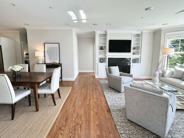126 Ridgewood Dr Unit L1, Falmouth, ME 04105 - living room with wood finished floors, a glass covered fireplace, and ornamental molding