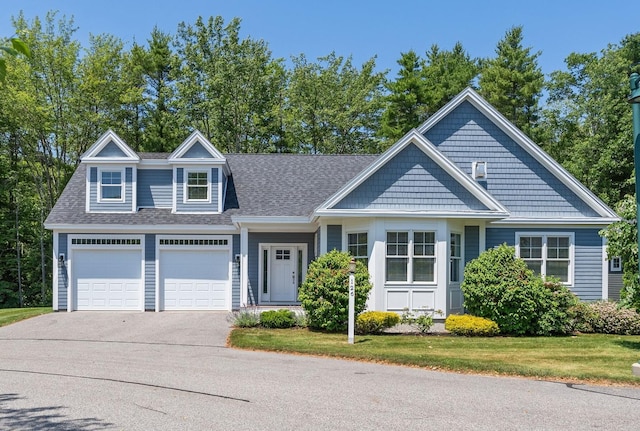 126 Ridgewood Dr Unit L1, Falmouth, ME 04105 - view of front facade featuring driveway, a front lawn, a shingled roof, and a garage
