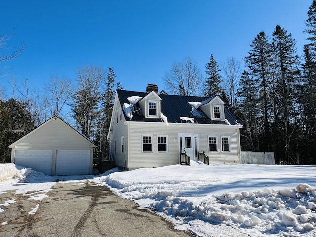 view of front of property with a garage, an outbuilding, and a chimney