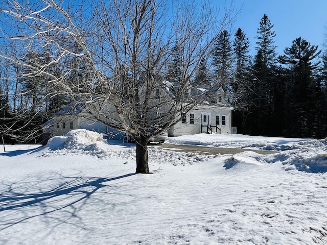 snowy yard with a garage