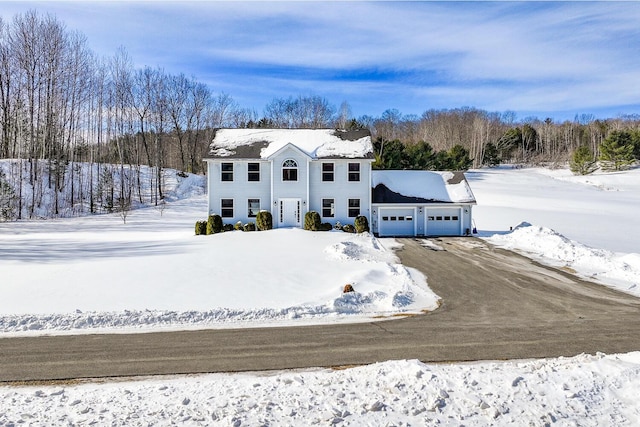 colonial home with a garage and driveway