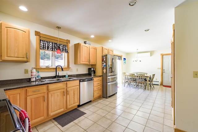 kitchen featuring pendant lighting, dark countertops, recessed lighting, appliances with stainless steel finishes, and a sink