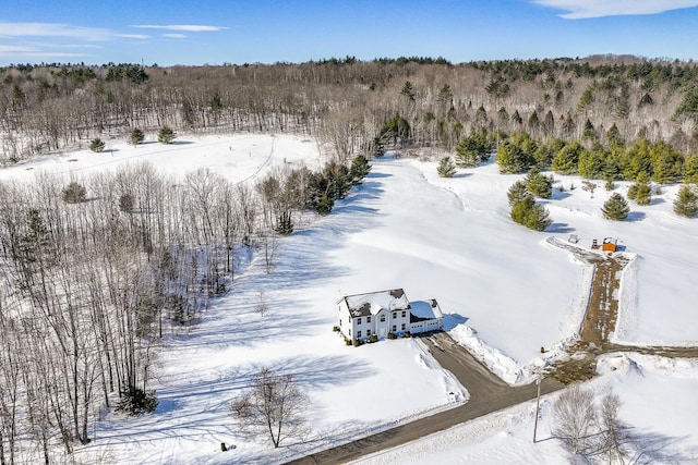 snowy aerial view featuring a view of trees