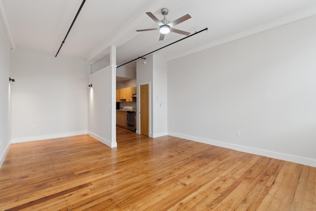 empty room with ceiling fan, light wood-type flooring, and baseboards