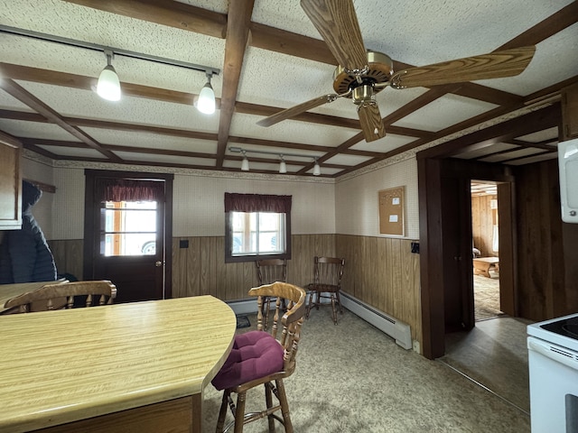143 Main St, Sangerville, ME 04479 - carpeted dining area featuring baseboard heating, coffered ceiling, wainscoting, a ceiling fan, and wood walls