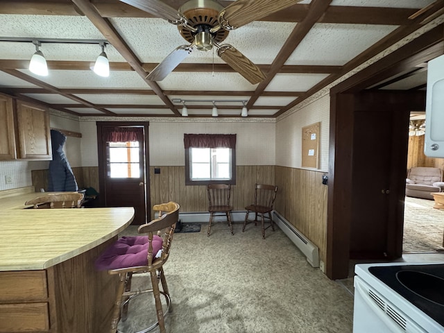 143 Main St, Sangerville, ME 04479 - kitchen featuring ceiling fan, coffered ceiling, wainscoting, light countertops, and wooden walls
