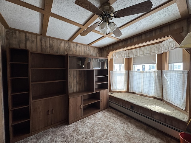 143 Main St, Sangerville, ME 04479 - unfurnished room featuring baseboard heating, wood walls, carpet floors, and ceiling fan