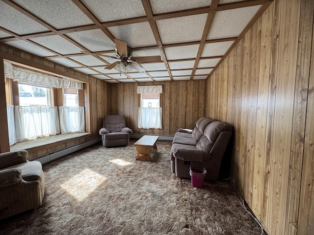 143 Main St, Sangerville, ME 04479 - sitting room with a baseboard radiator, a ceiling fan, wood walls, and carpet