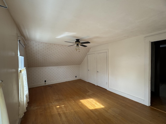 143 Main St, Sangerville, ME 04479 - additional living space featuring wallpapered walls, wood finished floors, a ceiling fan, baseboards, and vaulted ceiling