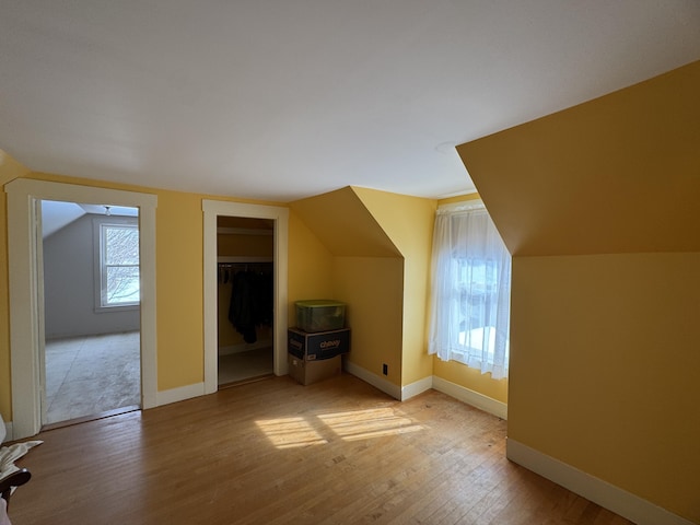 143 Main St, Sangerville, ME 04479 - additional living space with wood finished floors, healthy amount of natural light, baseboards, and vaulted ceiling
