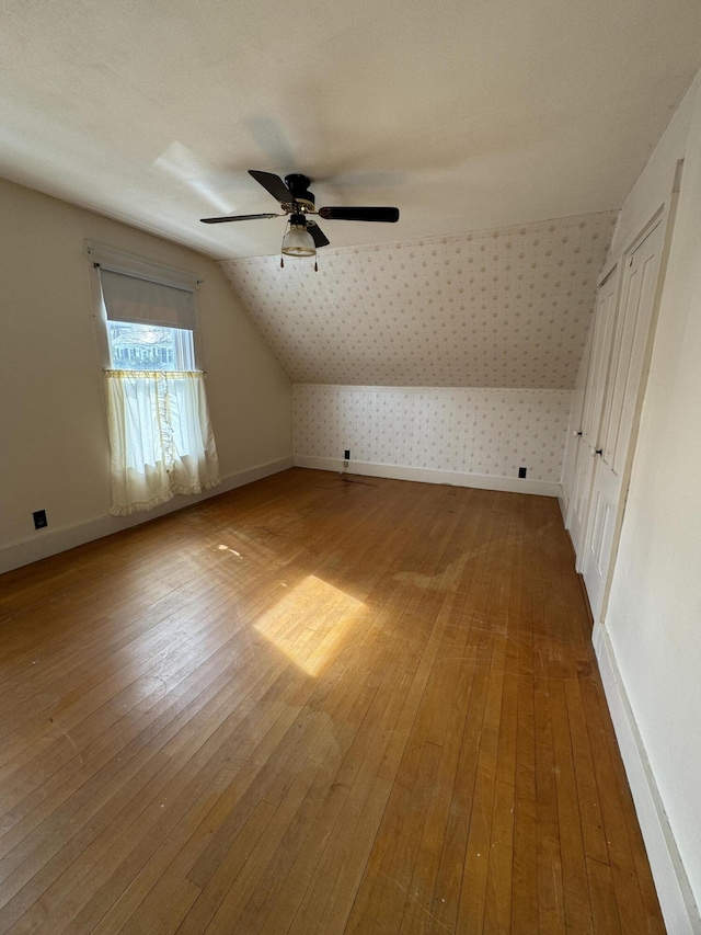 143 Main St, Sangerville, ME 04479 - additional living space featuring wallpapered walls, hardwood / wood-style flooring, a ceiling fan, lofted ceiling, and baseboards