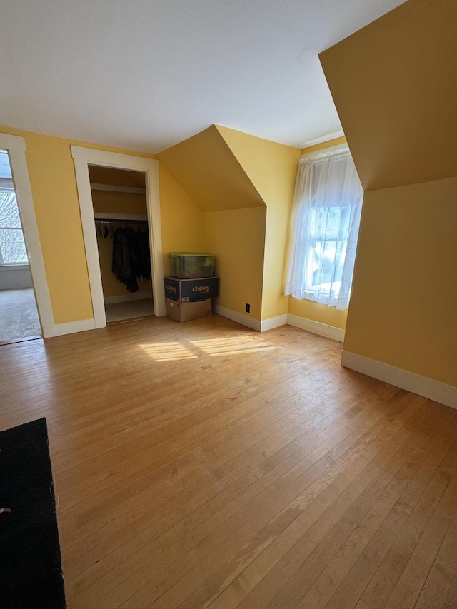 143 Main St, Sangerville, ME 04479 - additional living space with light wood-type flooring, vaulted ceiling, and baseboards