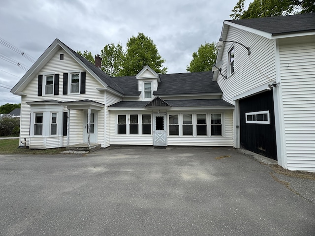 143 Main St, Sangerville, ME 04479 - view of front of property with a shingled roof, driveway, and a chimney