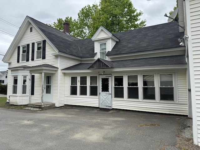 143 Main St, Sangerville, ME 04479 - rear view of house featuring a shingled roof and a chimney