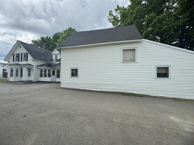 143 Main St, Sangerville, ME 04479 - view of side of property featuring roof with shingles