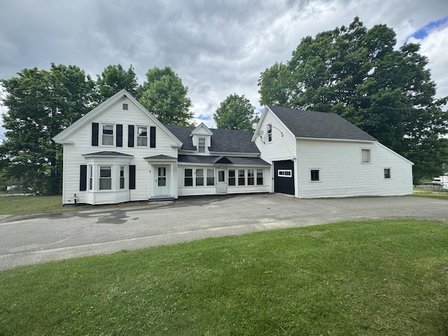 143 Main St, Sangerville, ME 04479 - view of front of home with asphalt driveway, a front yard, and roof with shingles